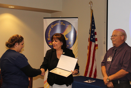 Graduate Nancy Mercado was a part of MOS53 Class, here receiving a Certificate of Completion by Ms. Amanda Aguirre, President and CEO of RCBH, and Instructor Mr. Mark Ballinger.